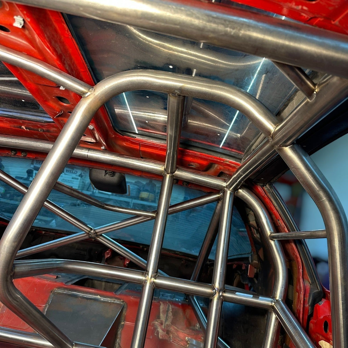 Henderson Race Shop 25.5 roll cage kit installed in a red 1982-1992 Camaro or Firebird with T-Tops
