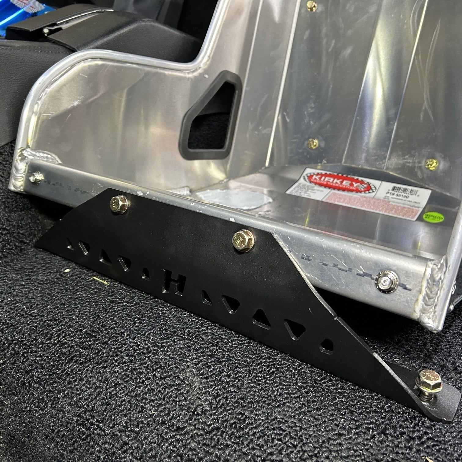 Henderson Race Shop black powder-coated steel seat mount bracket installed on a Kirkey racing seat in a C3 Corvette.