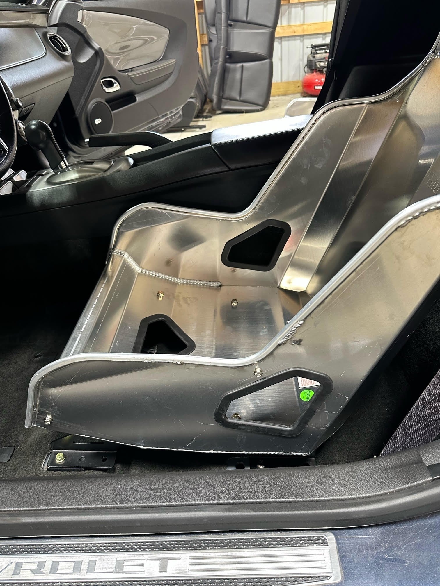 Henderson Race Shop black powder-coated steel seat mounts installed with a Kirkey racing seat in a Camaro interior