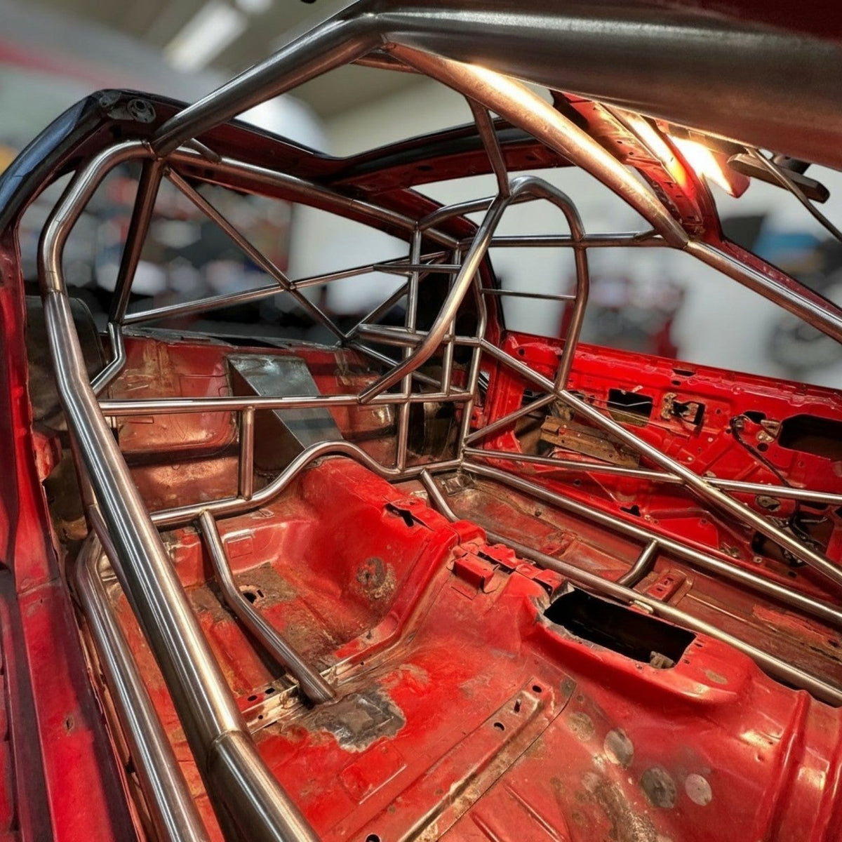 Henderson Race Shop Store 25.5 roll cage kit installed in a red 1982-1992 Camaro or Firebird with T-Tops