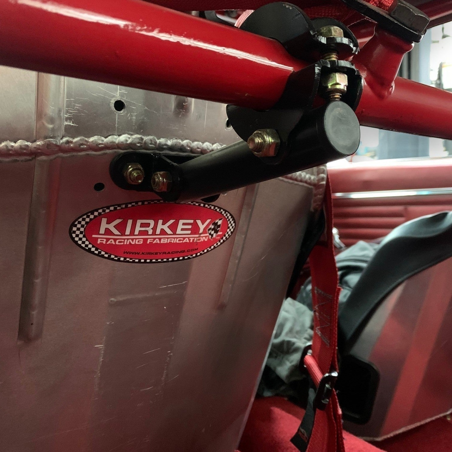 Henderson Race Shop Store bolt-on seat back brace installed on a racing seat with a black powder-coated finish.
