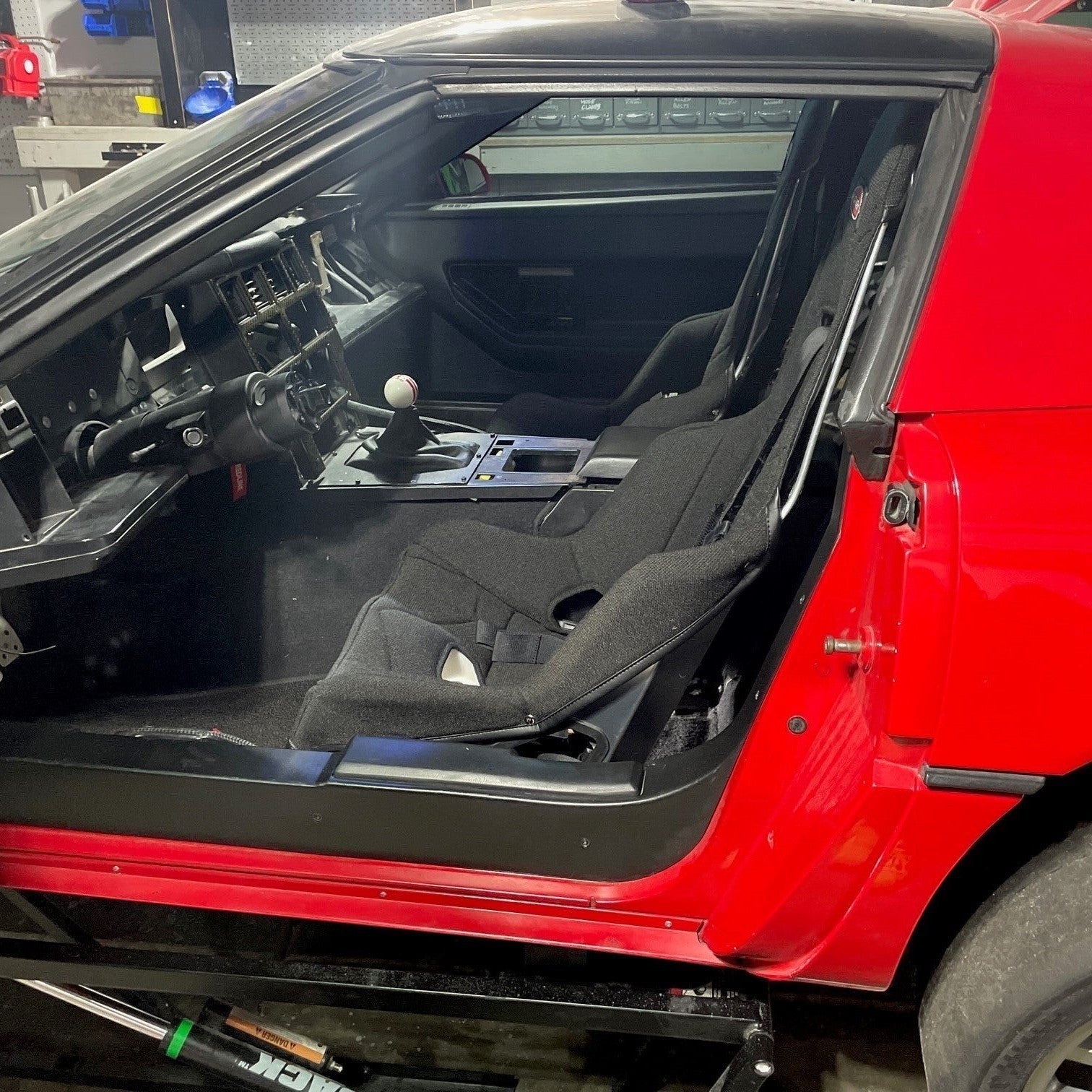 Henderson Race Shop Store seat mounts installed in a red C4 Corvette with a black Kirkey racing seat