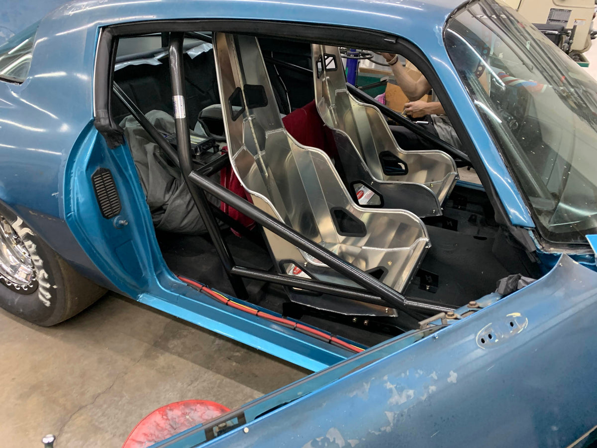 Henderson Race Shop Store seat mounts installed under aluminum racing seats in a blue 2nd Gen Camaro interior