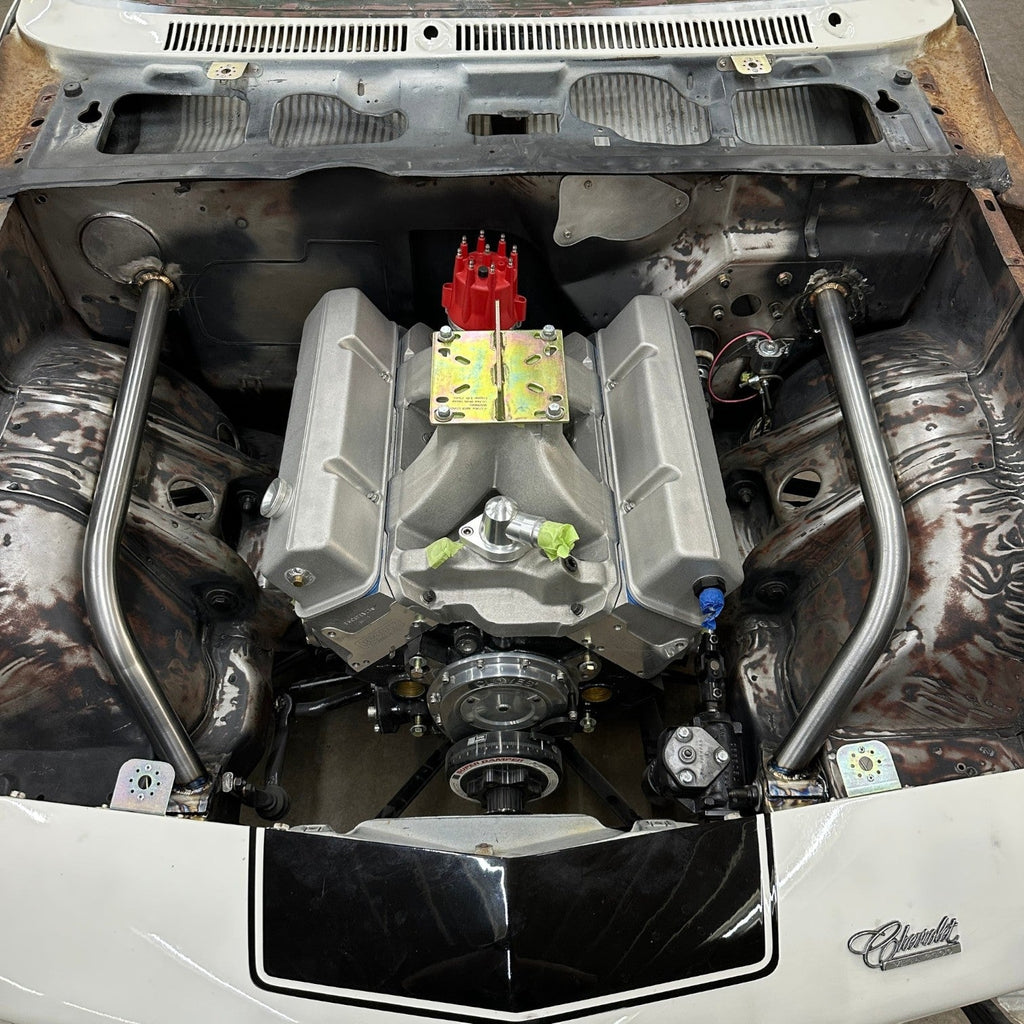 Henderson Race Shop Store 8.50 roll cage bars installed in a 1971-1977 Chevy Vega engine bay with a racing engine.