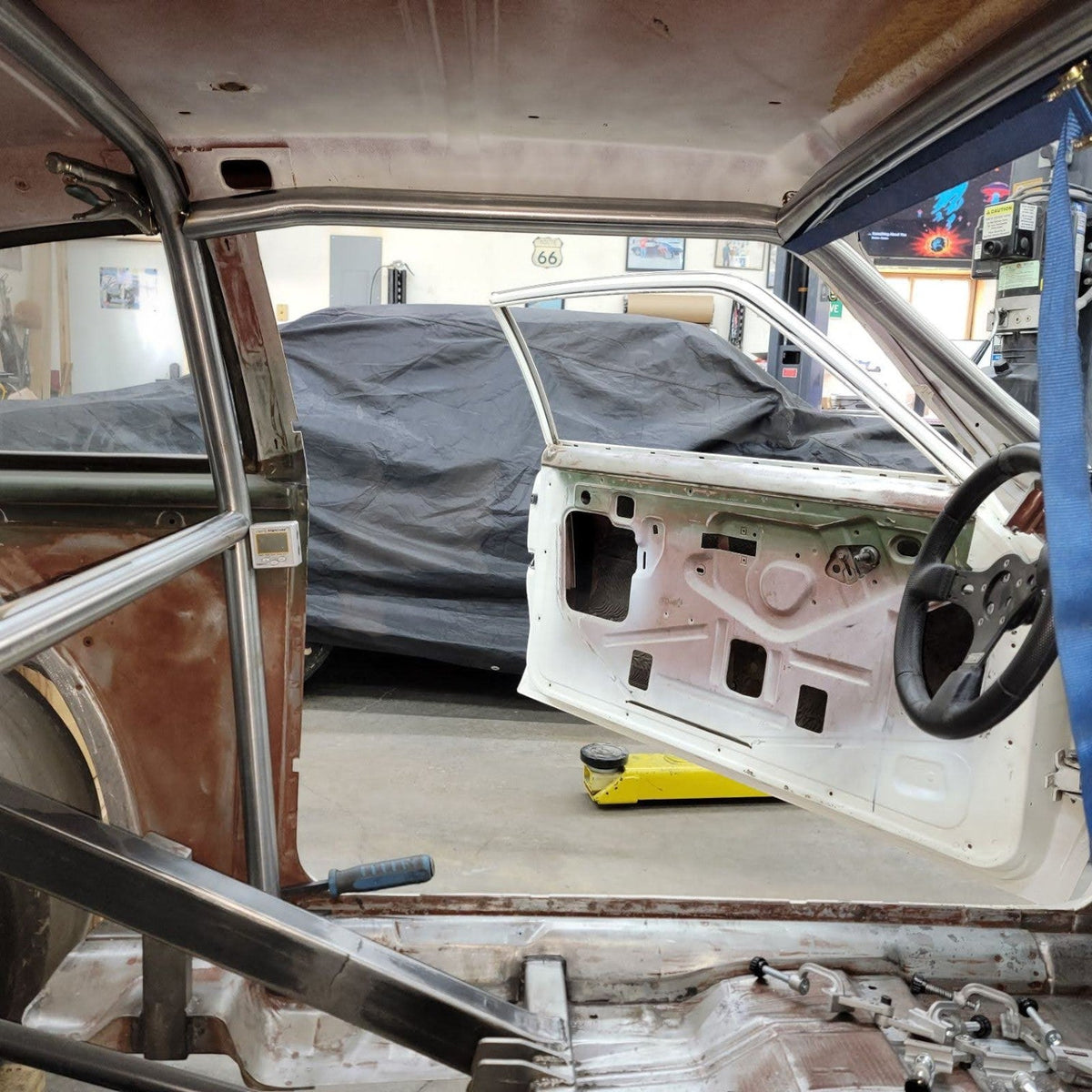 Henderson Race Shop Store 8.50 roll cage kit installed in a 1971-1977 Chevy Vega showing precision fit metal tubing