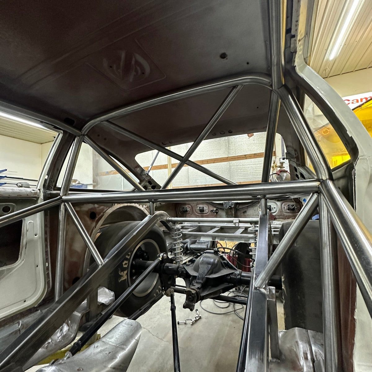 Henderson Race Shop Store 8.50 roll cage installed in a 1971-1977 Chevy Vega with rear X-bracing and main hoop.