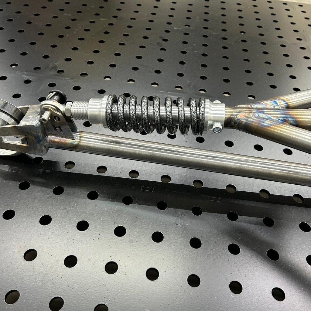 Henderson Race Shop Store chromoly single wheelie bar featuring a heavy-duty spring slider assembly on a pegboard.