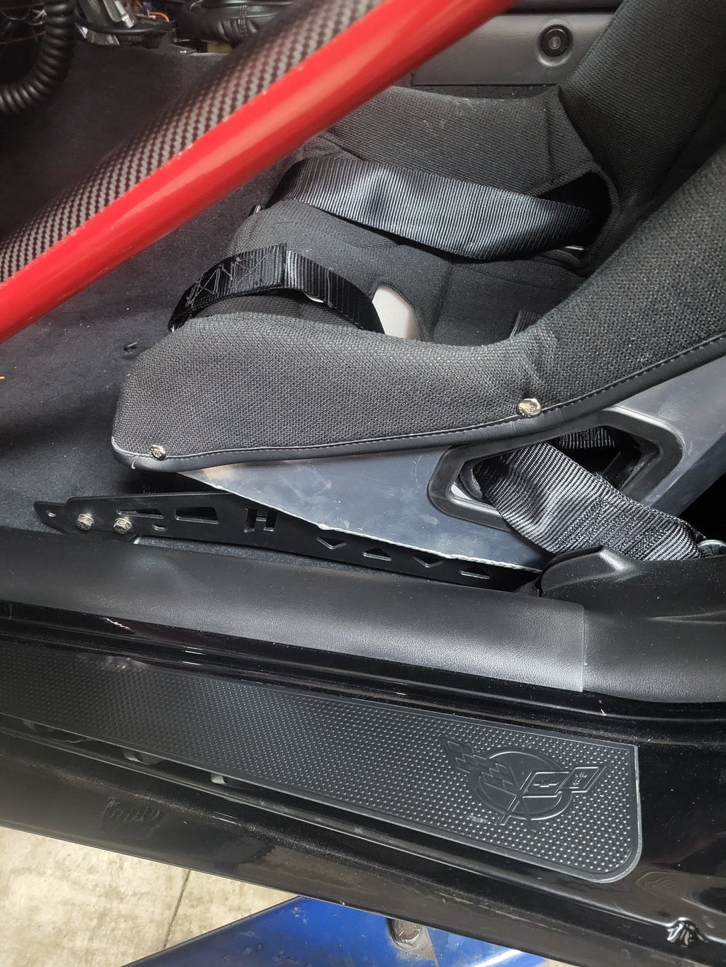 Henderson Race Shop Store black steel seat mount bracket installed with a Kirkey racing seat in a Chevrolet Corvette