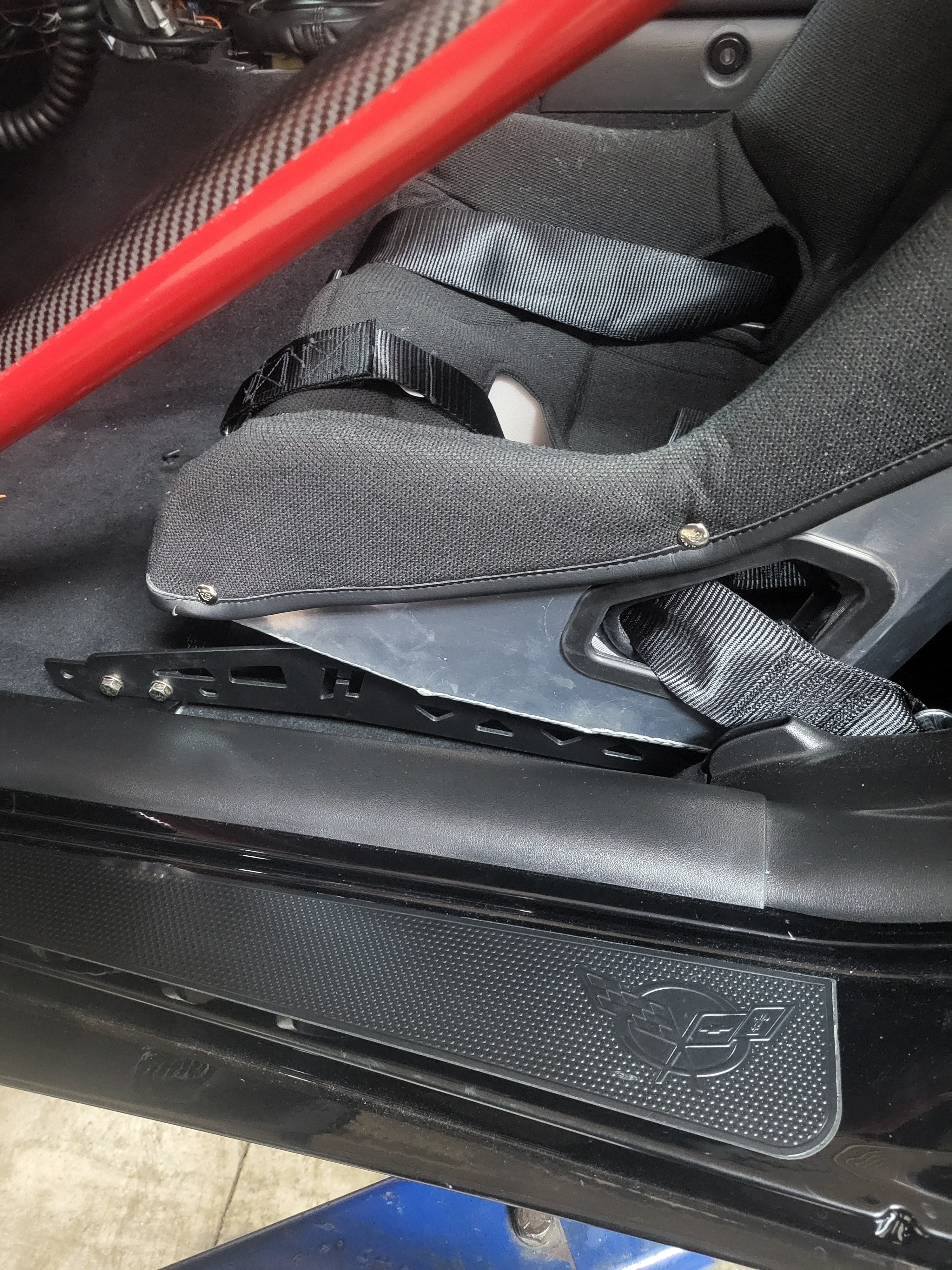 Henderson Race Shop Store black steel seat mount bracket installed with a Kirkey racing seat in a Chevrolet Corvette