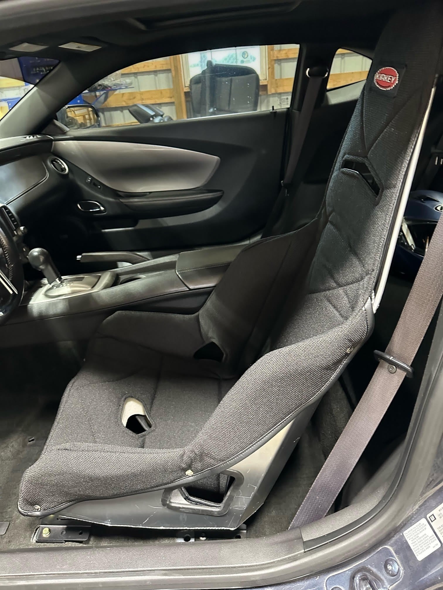 Henderson Race Shop Store black Kirkey racing seat installed in a vehicle interior using custom steel seat mounts