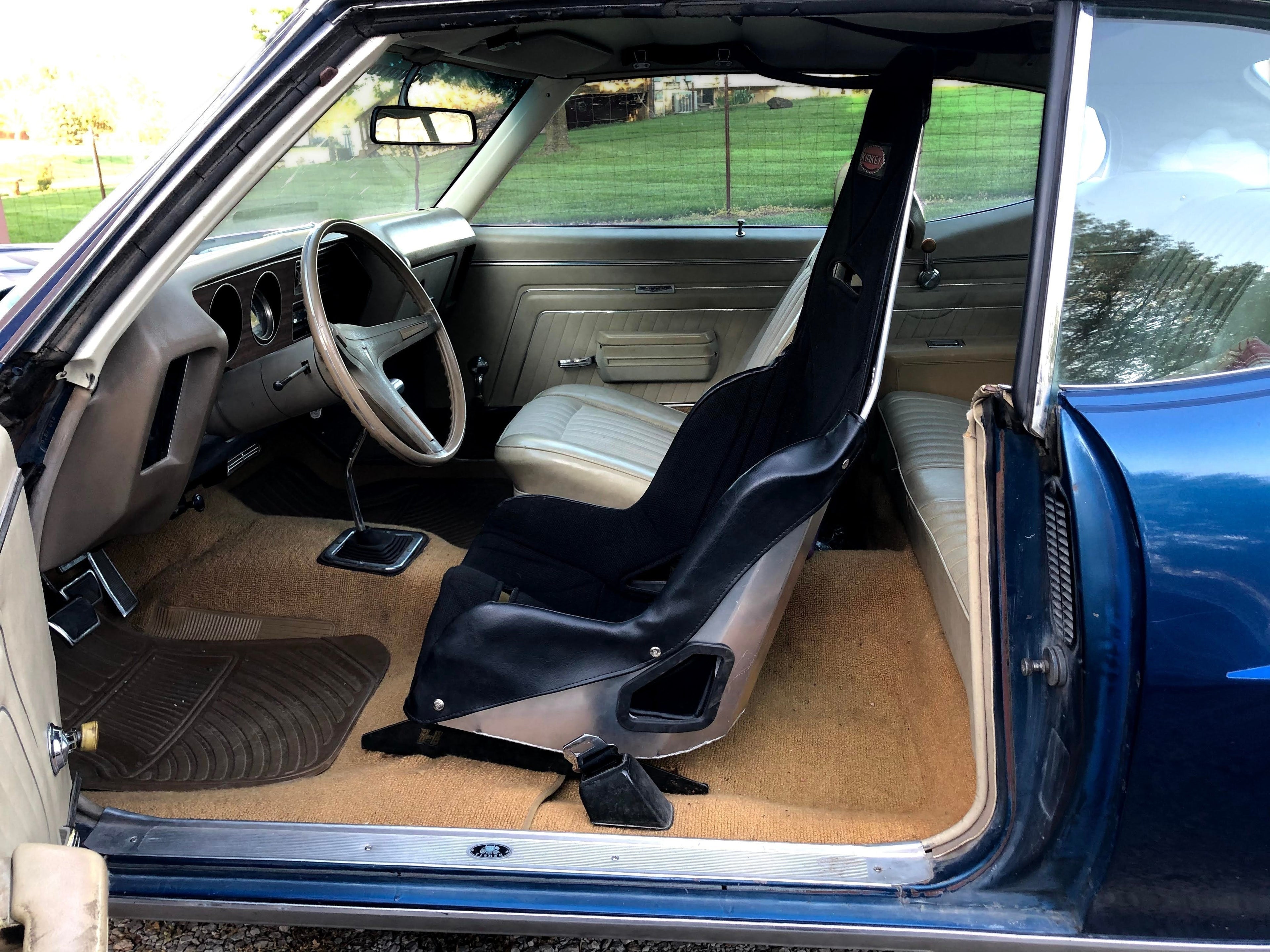Henderson Race Shop Store Kirkey racing seat installed in a classic GM A-Body interior with tan carpet