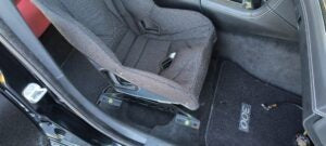Henderson Race Shop Store seat mounts installed with a black Kirkey racing seat in a Dodge Charger interior