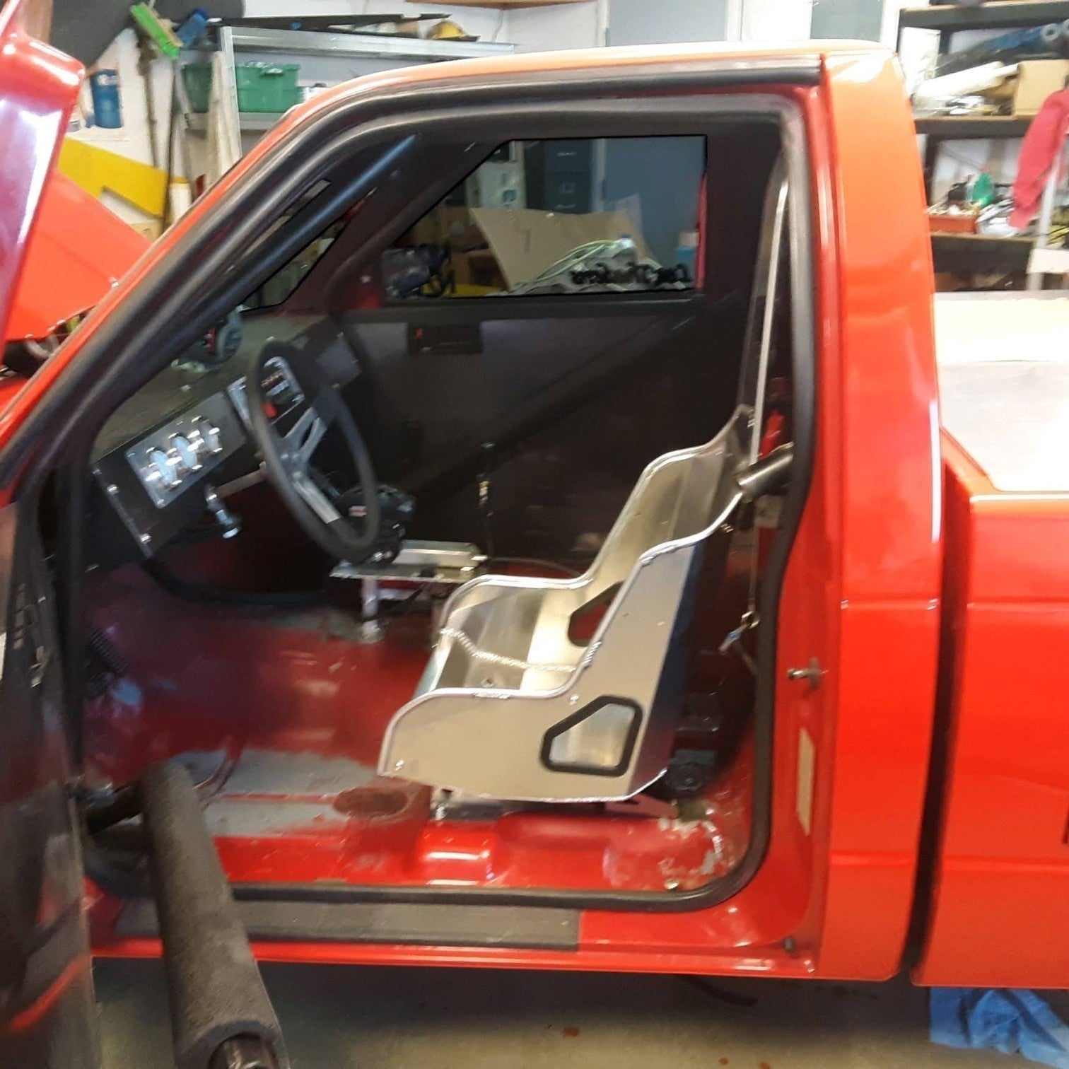 Henderson Race Shop Store seat mounts installed with a Kirkey racing seat in a red GM S-Series truck interior
