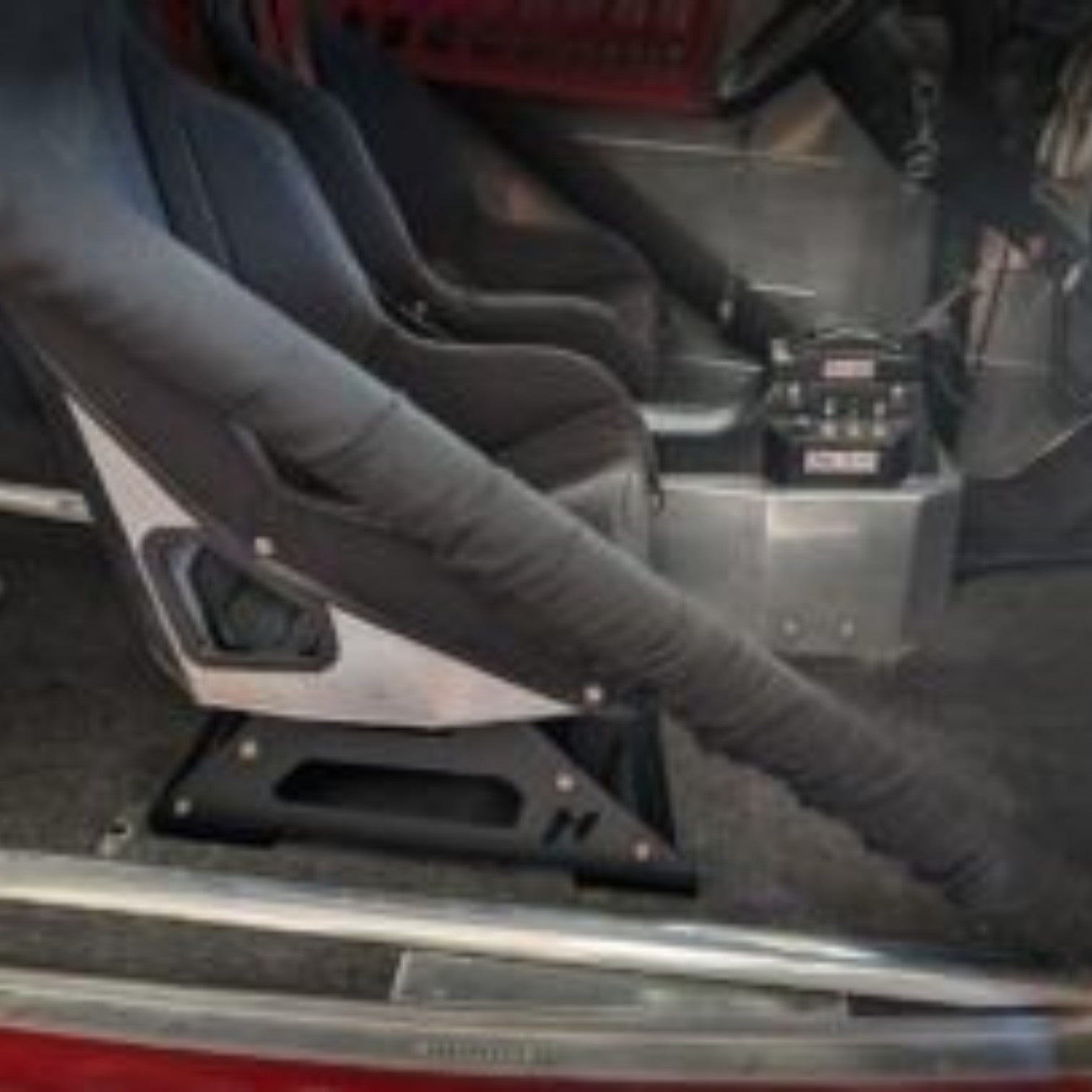 Henderson Race Shop Store universal seat mount brackets installed under a Kirkey racing seat in a vehicle interior