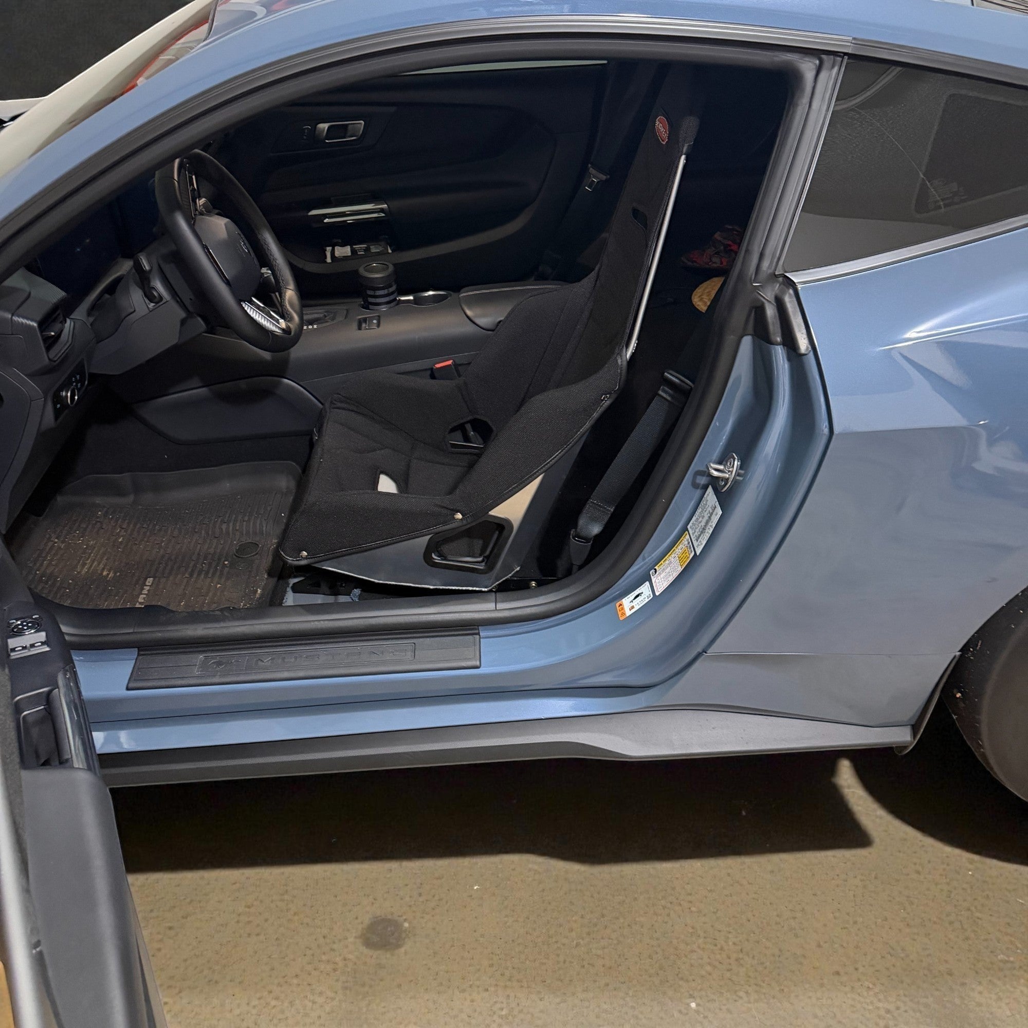 Henderson Race Shop Store seat mount installed with a black Kirkey racing seat inside a blue Ford Mustang S550