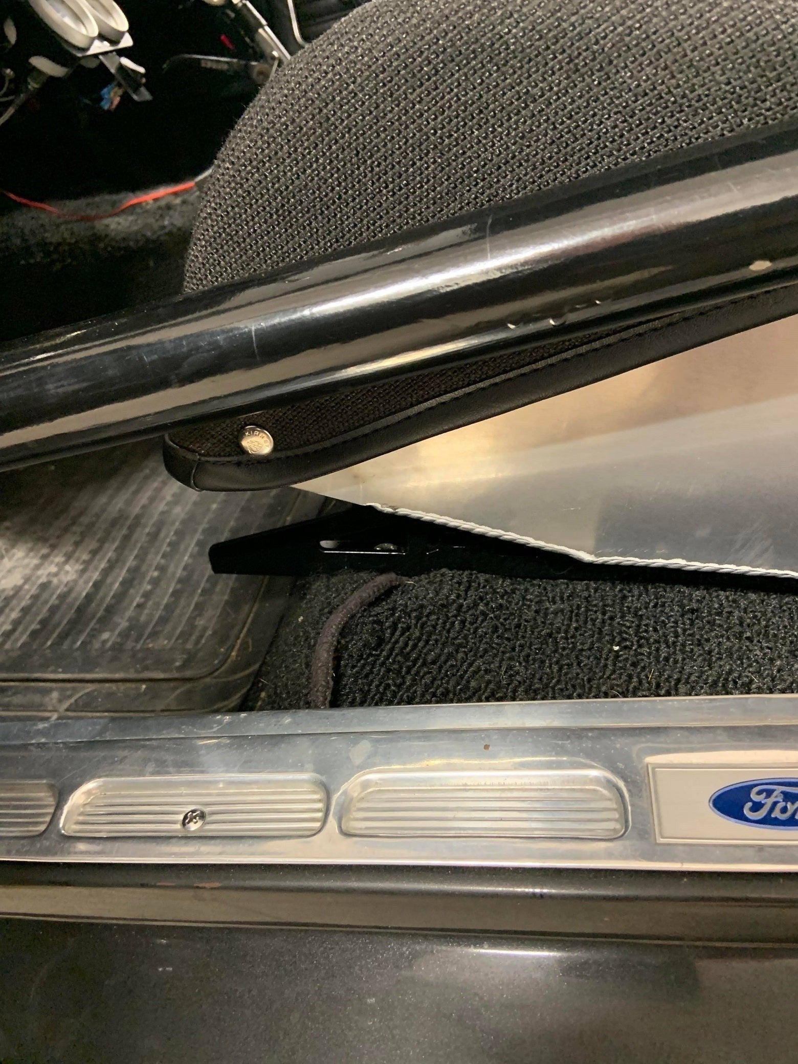 Henderson Race Shop Store black steel seat mount bracket installed under a Kirkey racing seat in a classic Mustang