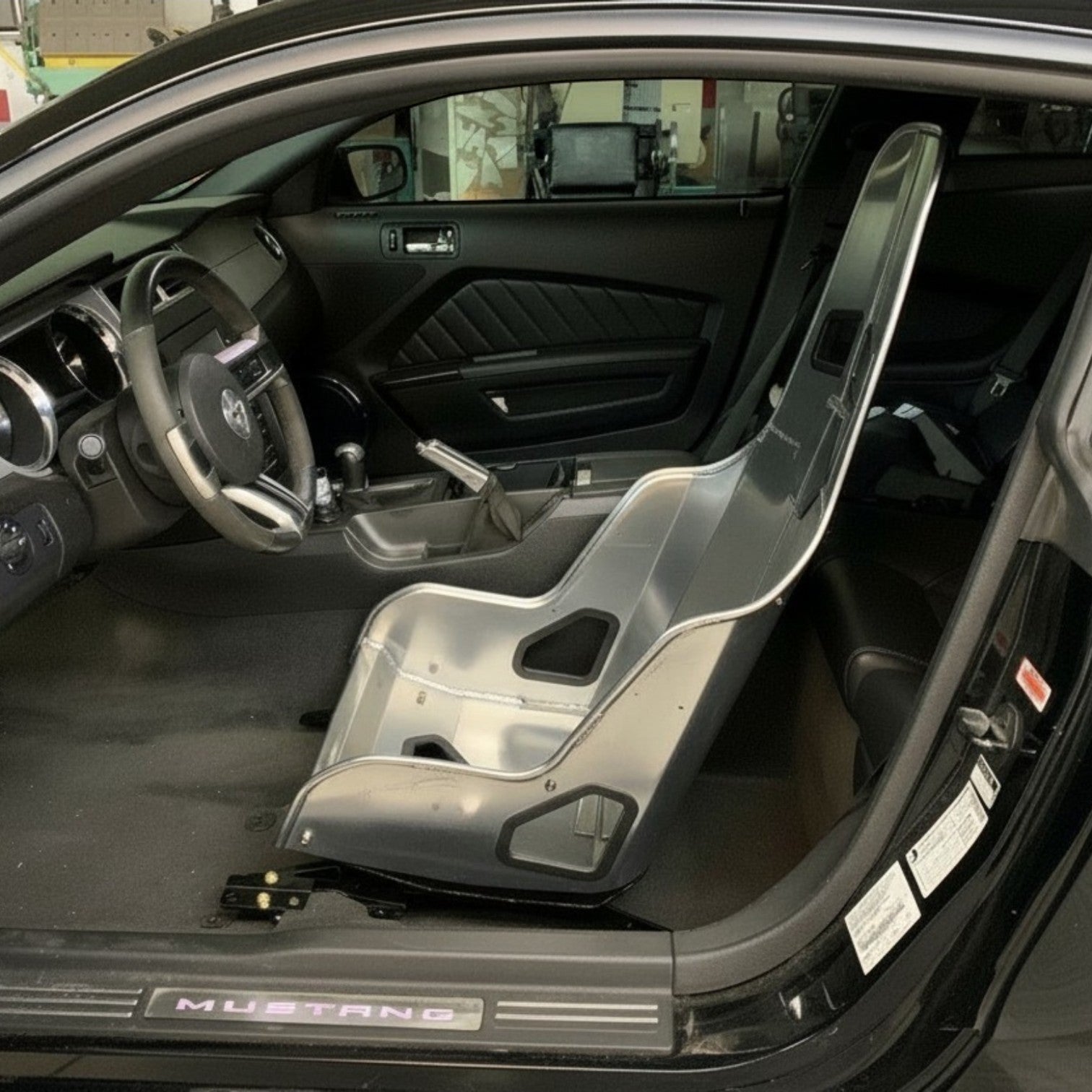 Henderson Race Shop Store seat mounts installed with a Kirkey racing seat inside a 2005-2014 Ford Mustang S197 interior