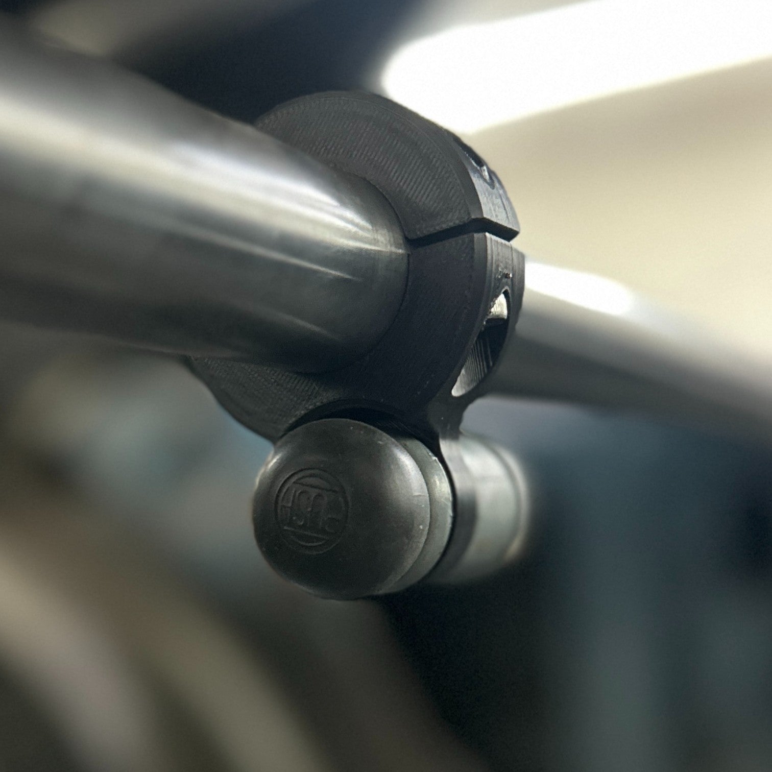Henderson Race Shop Store black ASA bump switch clamp mounted on a roll bar with a rubber boot switch installed