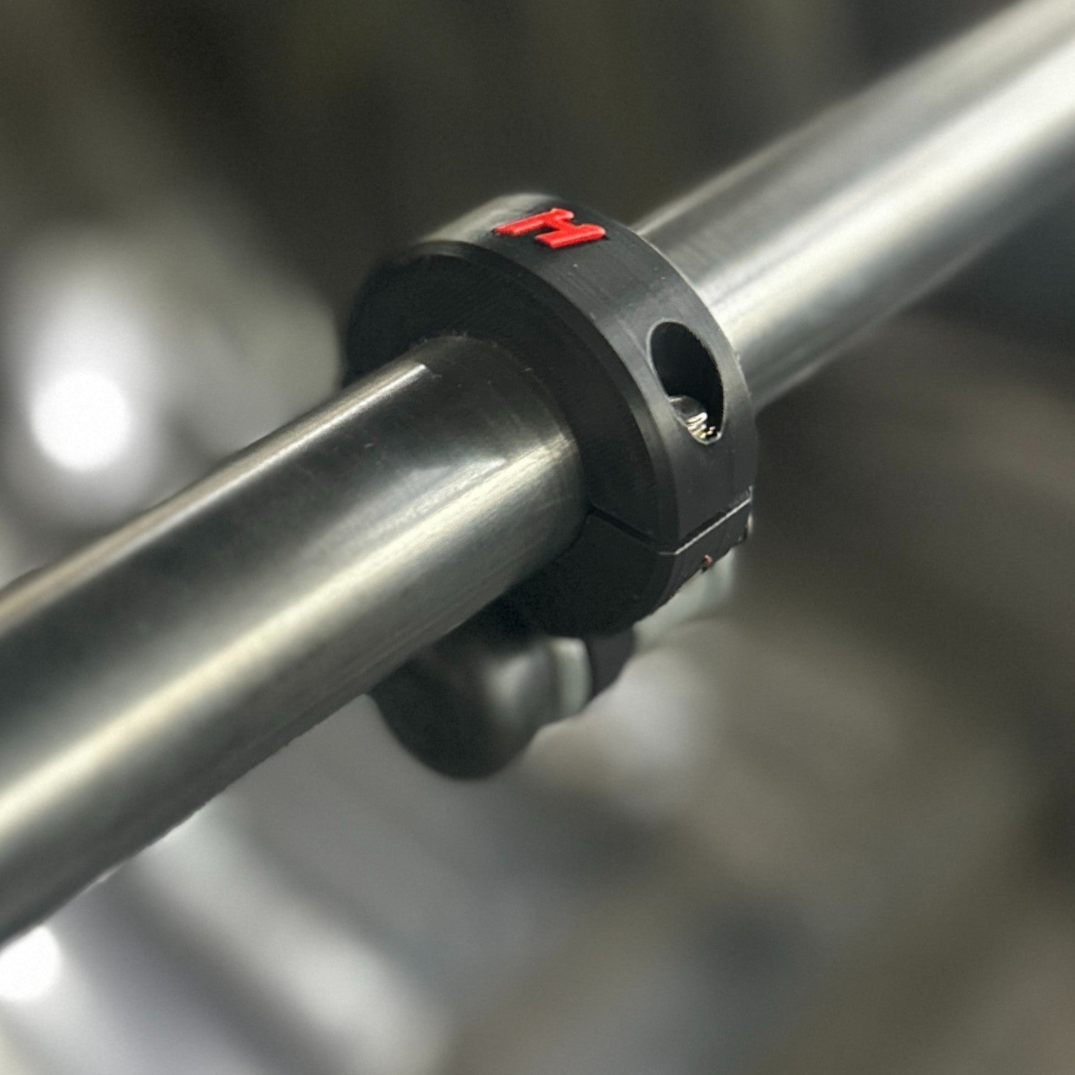 Henderson Race Shop Store black ASA roll bar bump switch clamp mounted on metal tubing with a red H logo