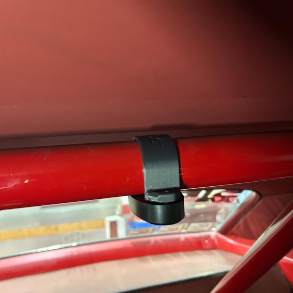 Henderson Race Shop Store roll cage LED light mounted on a red racing tube with a durable black ASA clamp