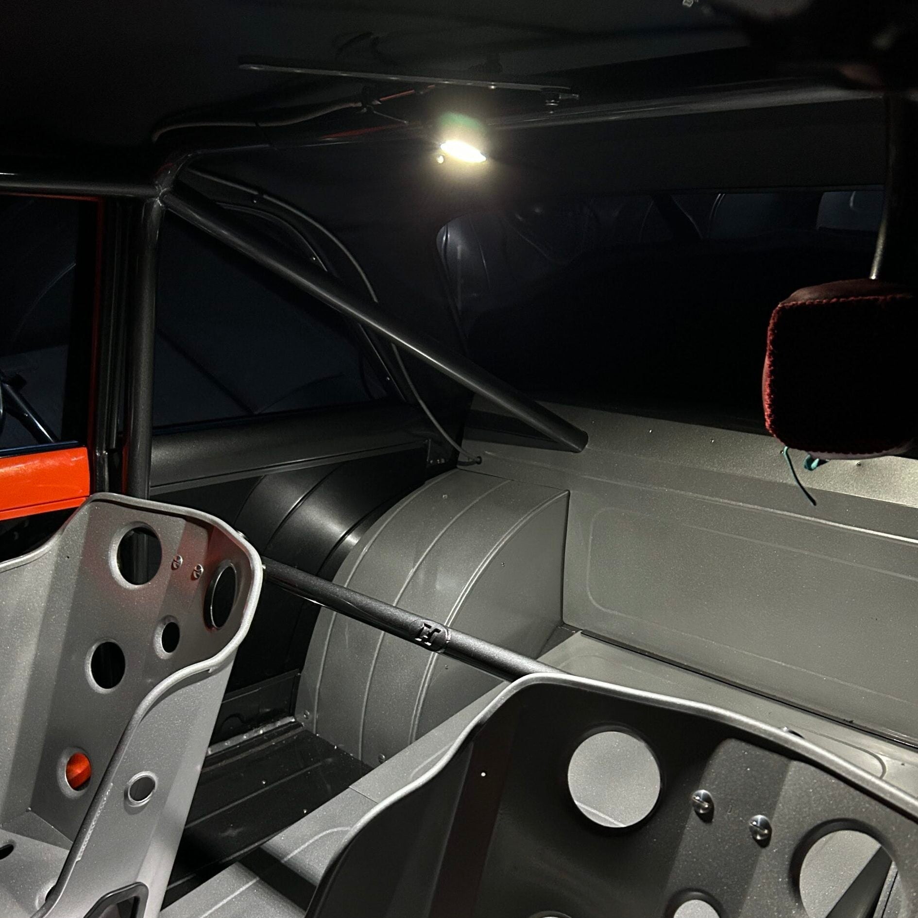 Henderson Race Shop Store LED light mounted on a race car roll cage, providing bright white interior illumination.