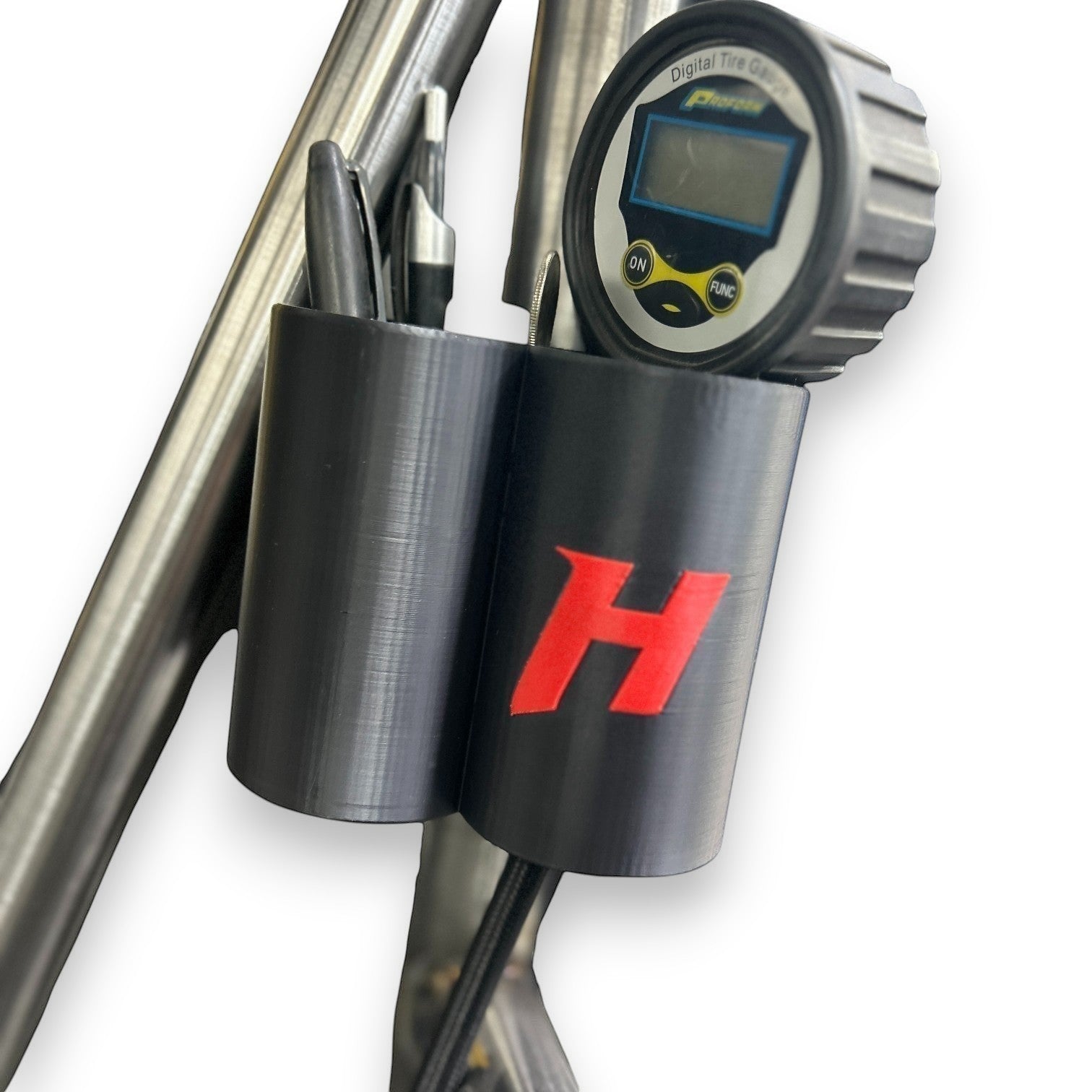 Henderson Race Shop Store roll cage mounted organizer holding a tire pressure gauge and pens on a race car frame