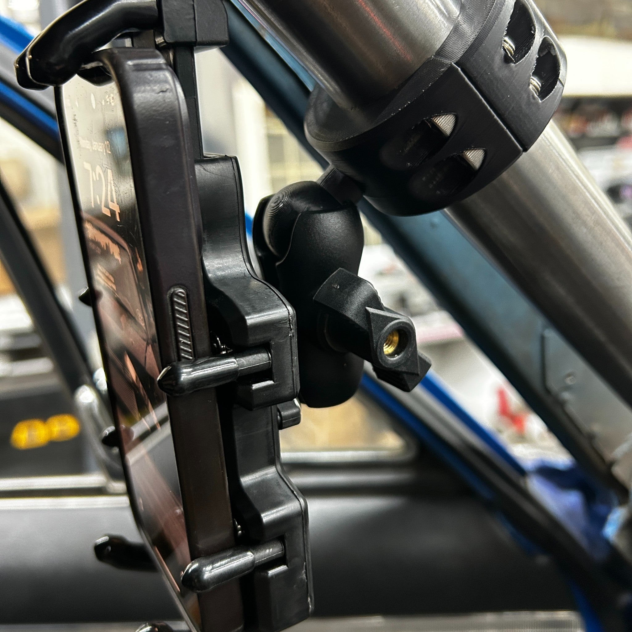 Henderson Race Shop Store roll cage phone mount with RAM style ball joint attached to a metal roll bar in a race car