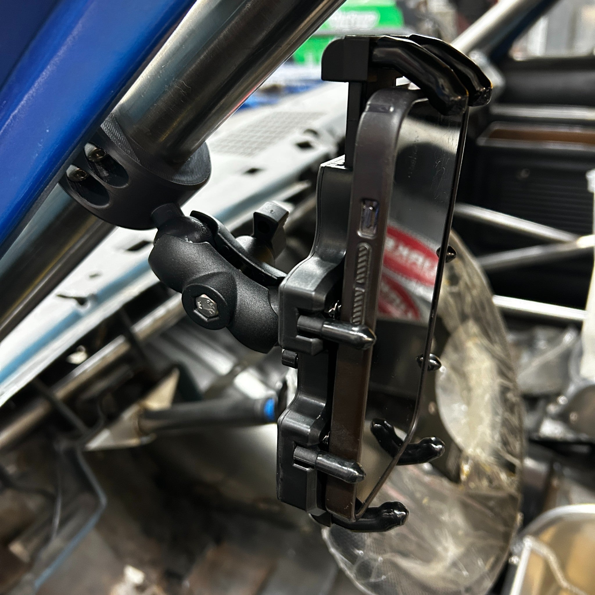 Henderson Race Shop Store roll cage phone mount with four-sided grip and adjustable ball joint on race car tubing