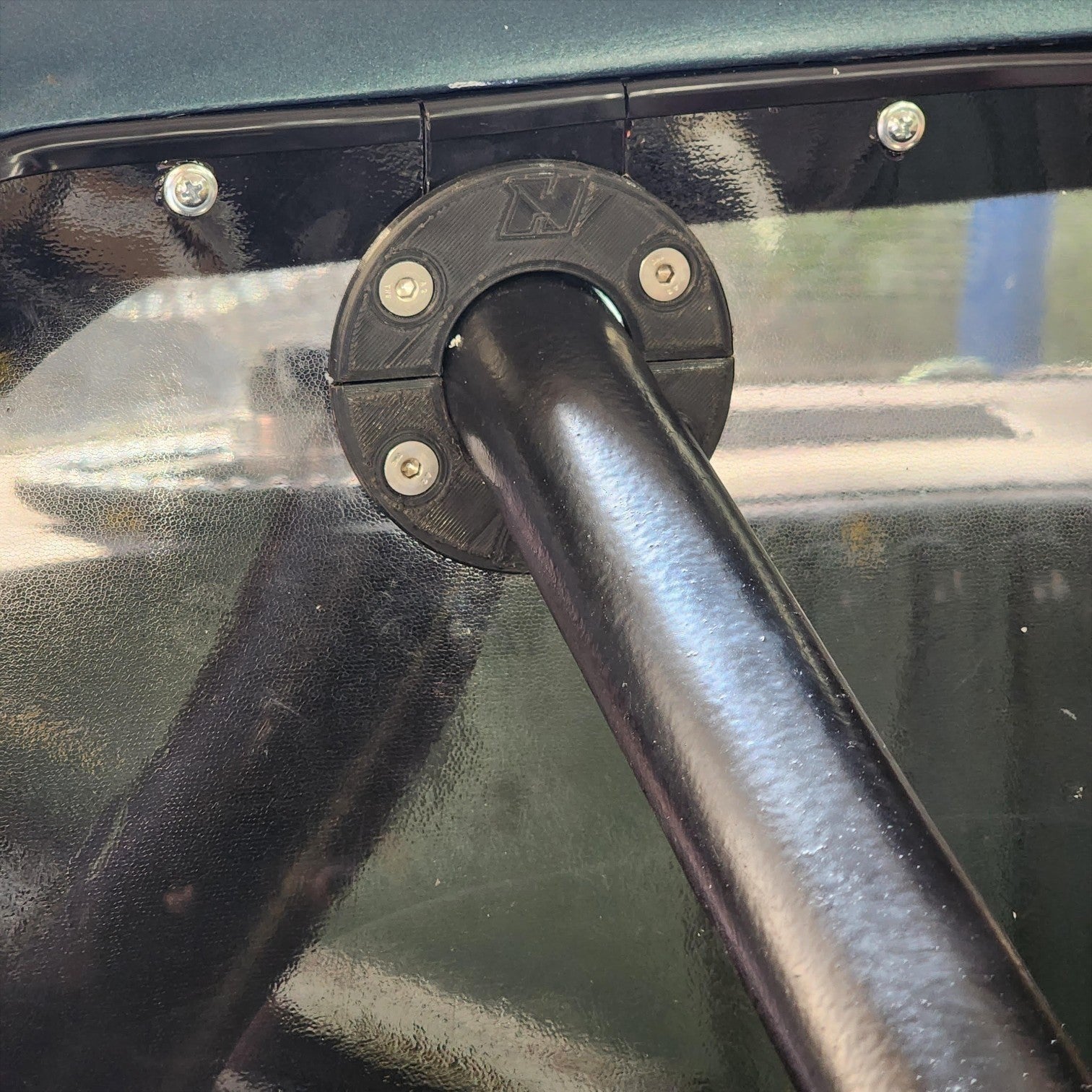 Henderson Race Shop Store black roll cage trim plate installed around a support bar on a rear deck