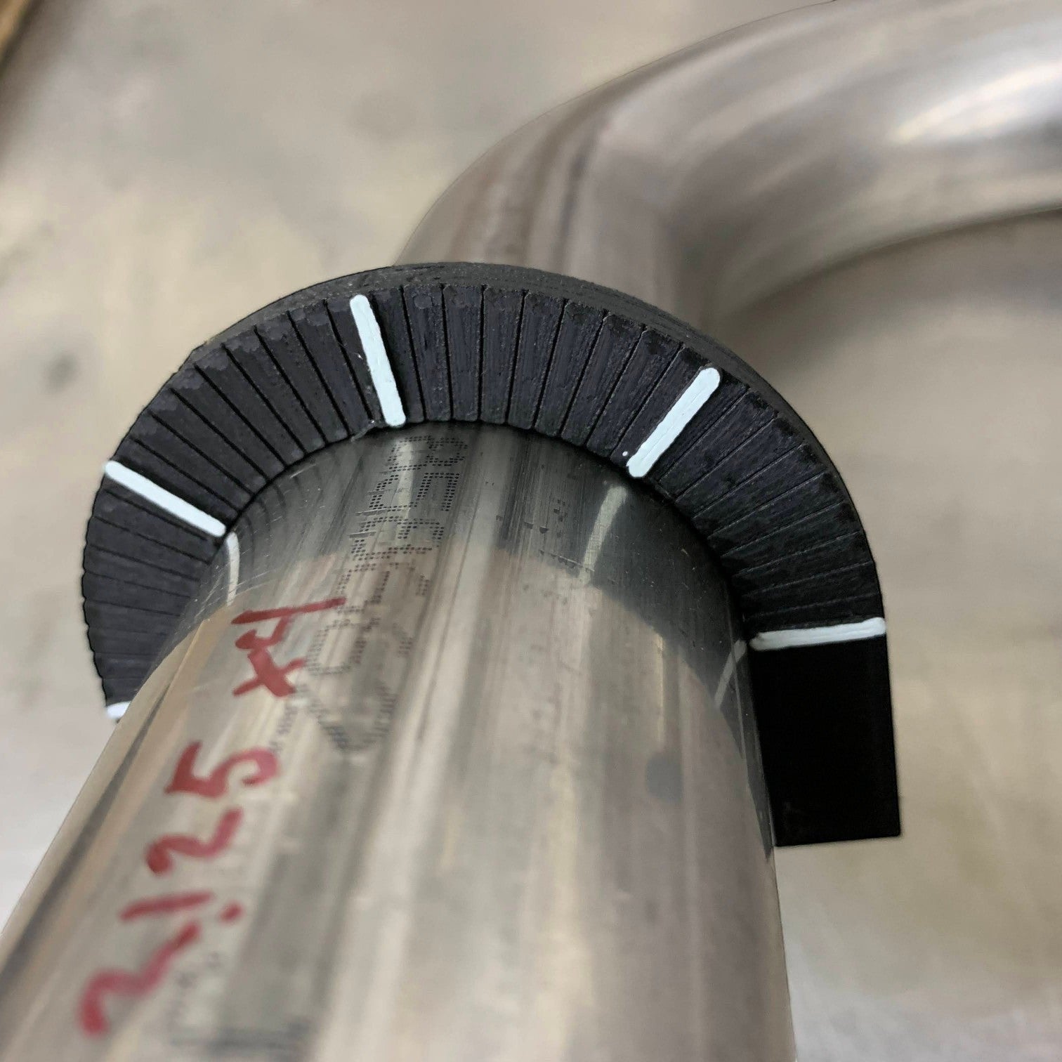 Henderson Race Shop Store rotational layout tool snapped onto a metal tube for marking precise rotational angles.