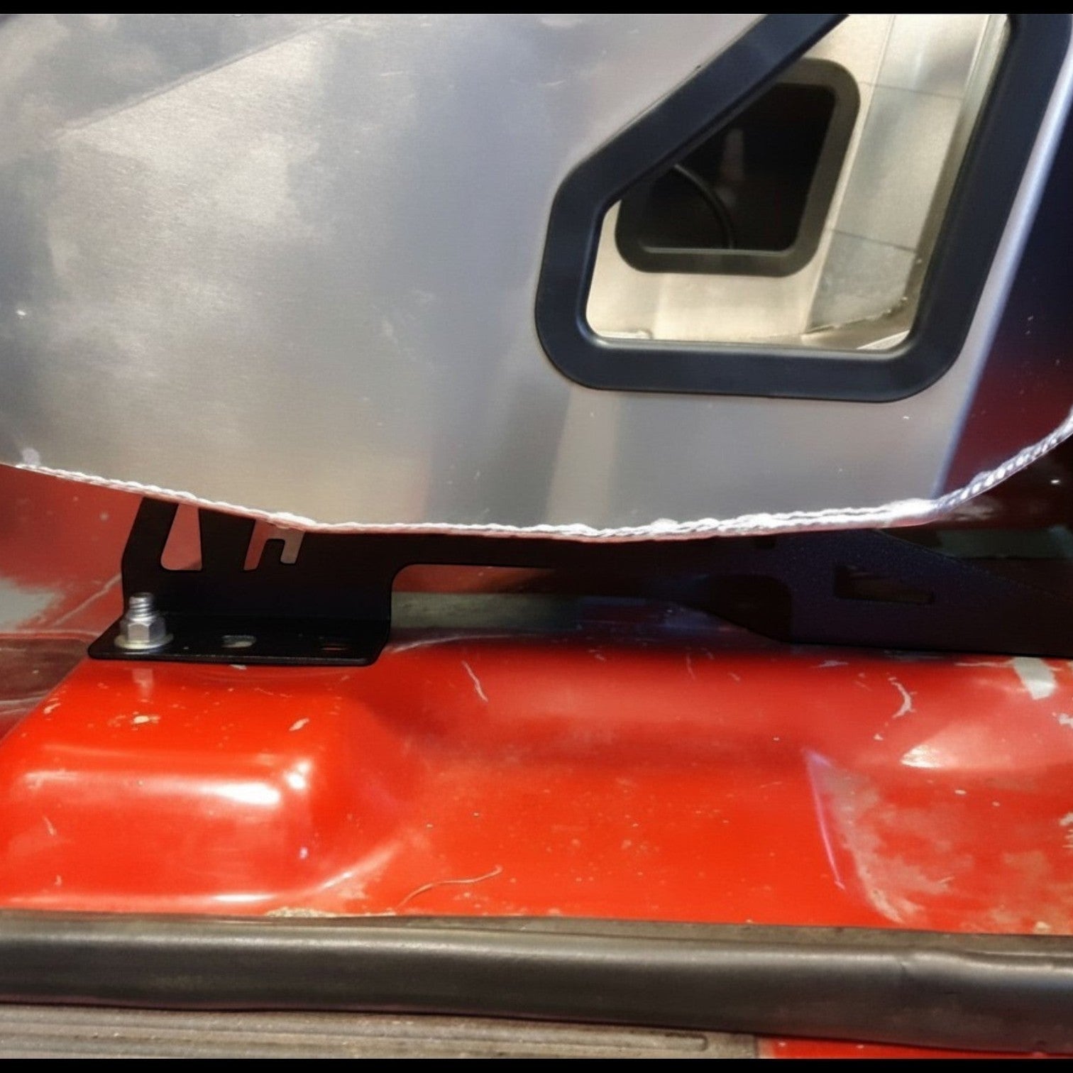 Henderson Race Shop Store black steel seat mount bracket installed under a Kirkey racing seat in a GM S-Series truck.