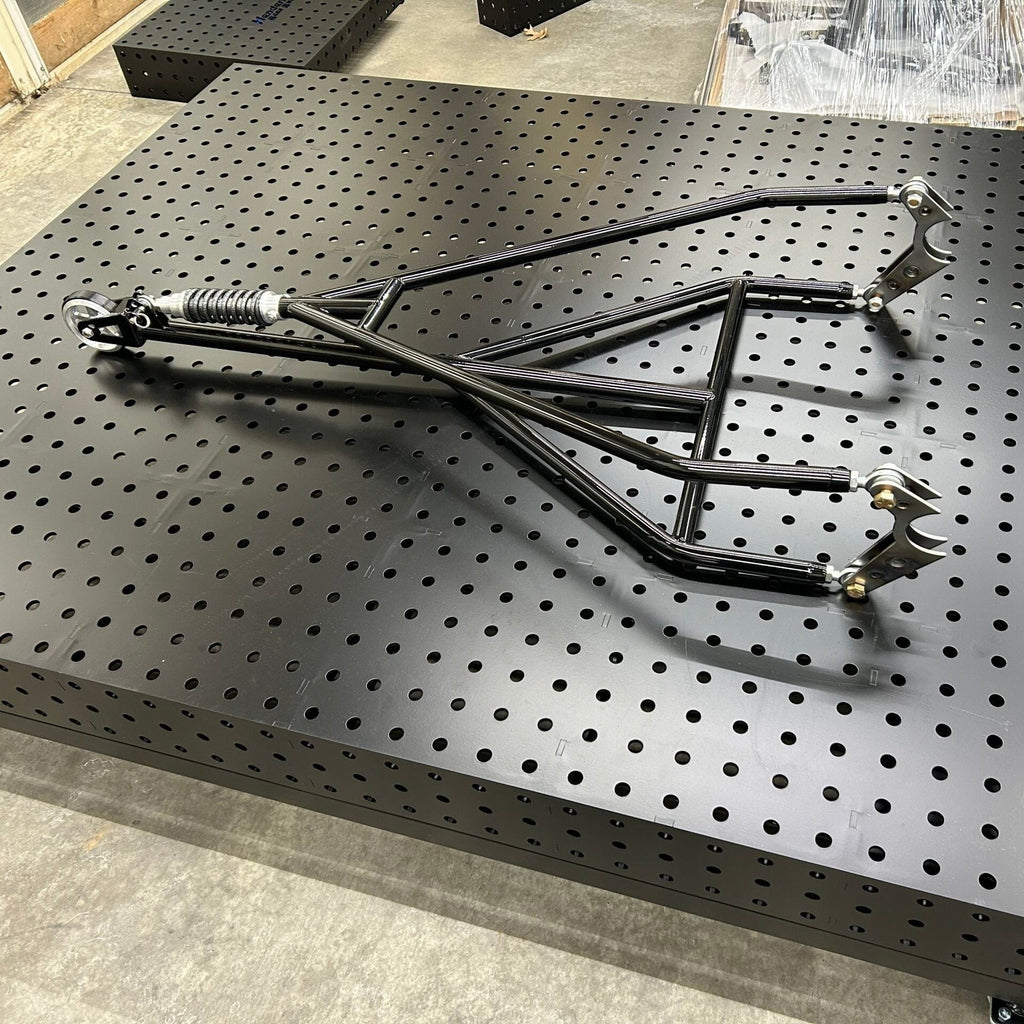 Henderson Race Shop Store single wheelie bar with heavy duty spring slider and chromoly construction on a welding table