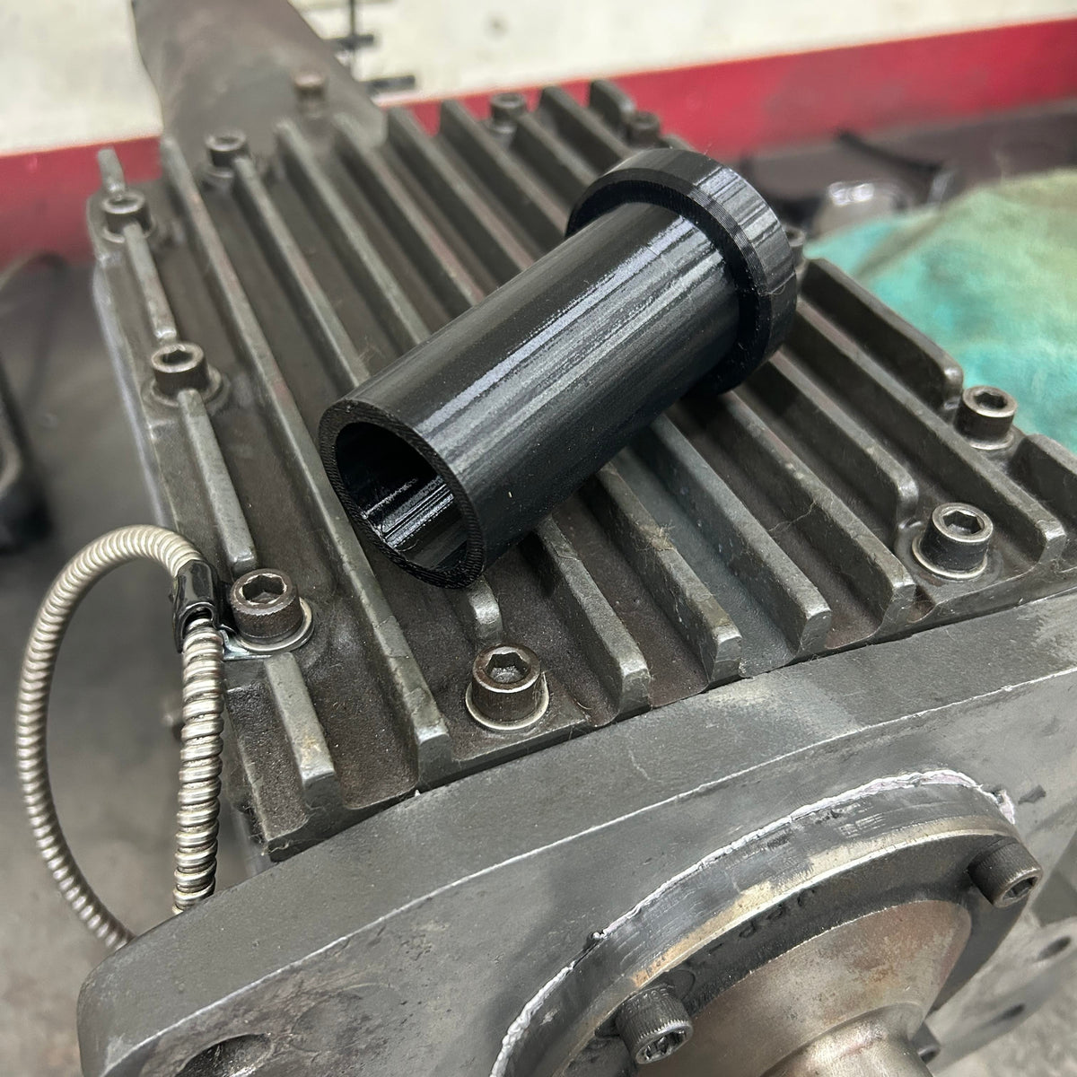Henderson Race Shop Store black plastic transmission input shaft alignment tool resting on a ribbed metal gearbox