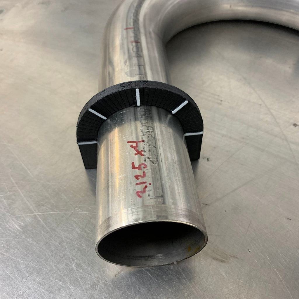 Henderson Race Shop Store rotational layout tool snapped onto a metal tube for accurate angle marking on a workbench