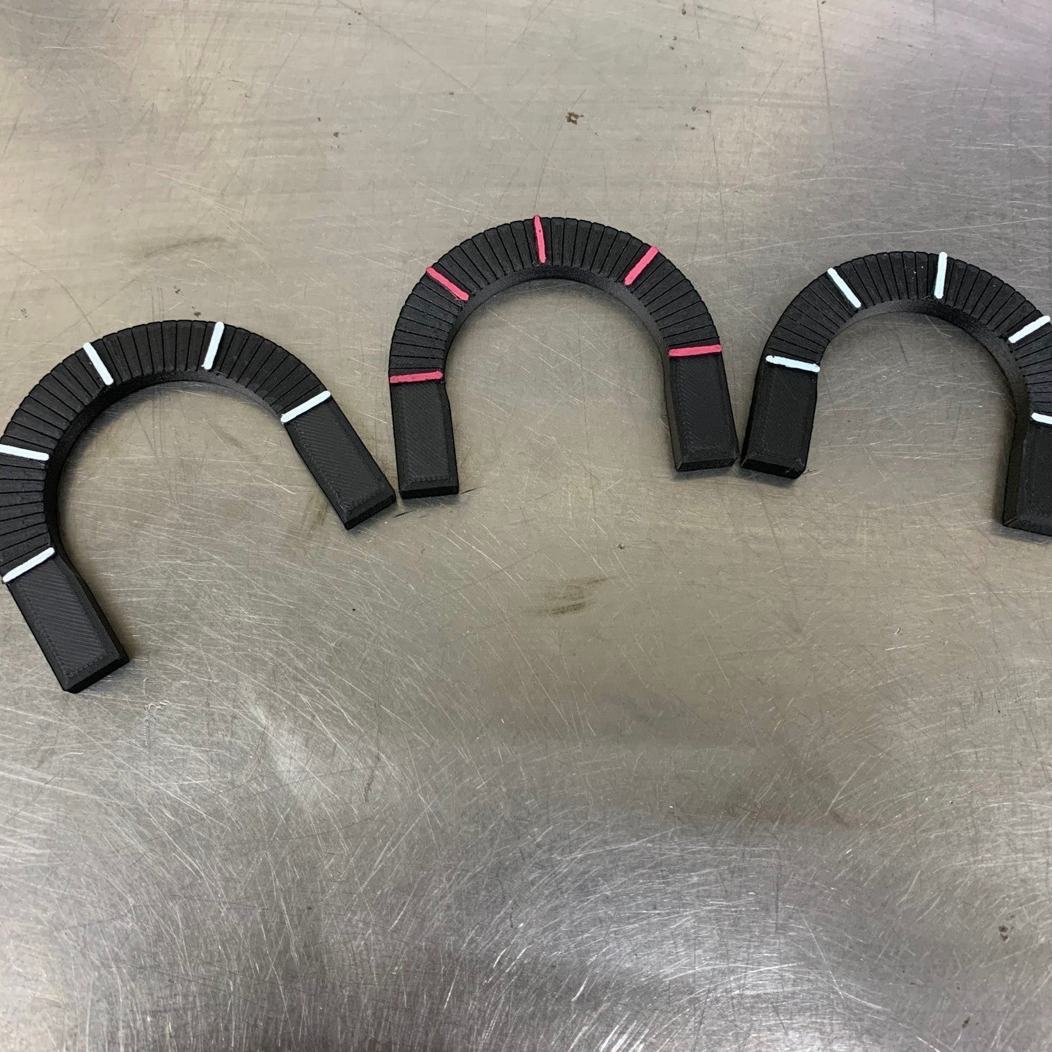 Henderson Race Shop Store rotational layout tools for marking tubing angles on a metal workbench