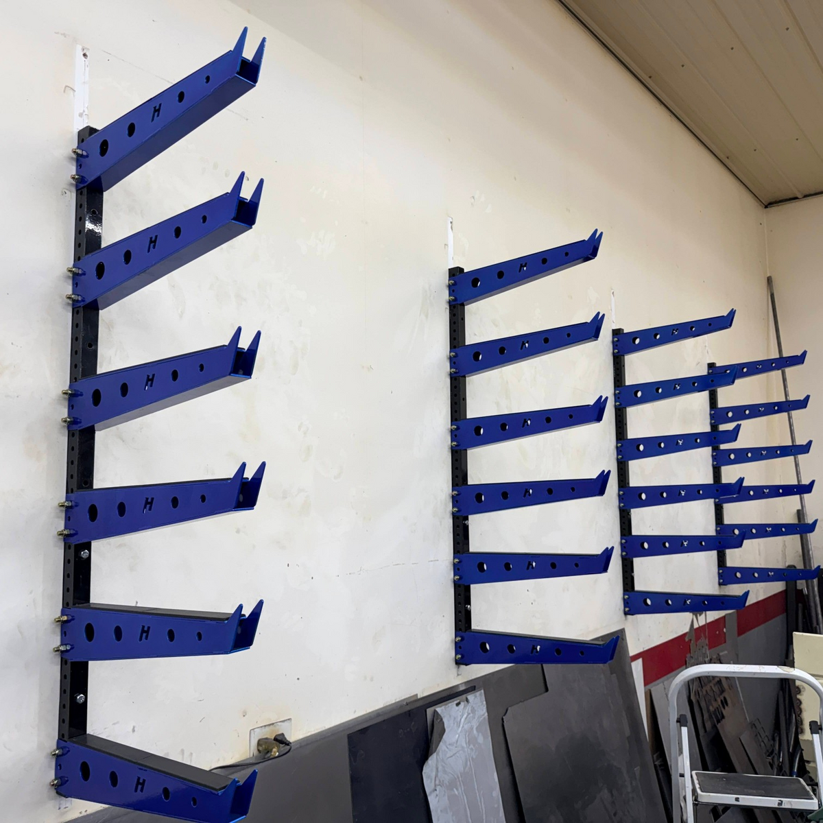 Henderson Race Shop Store wall mounted blue metal storage rack with 18-inch arms for shop organization