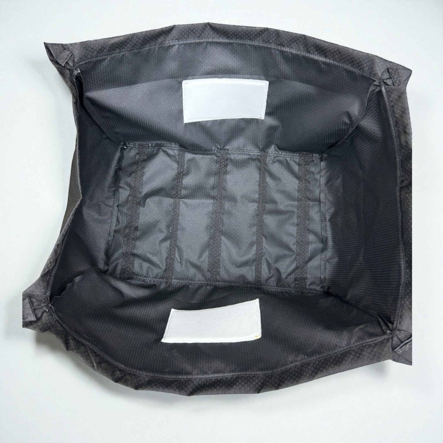 Henderson Race Shop Store Wheel Cribz protective covers made of black 300D hexagon grid ripstop fabric with padding.